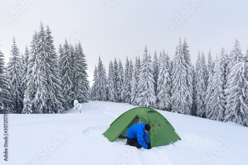 Green tent in winter mountains