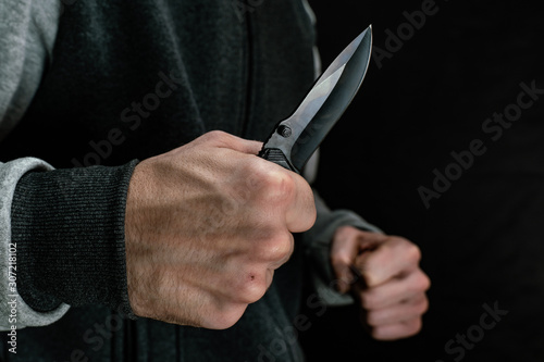 Close-up of an attacker with a knife in his hand