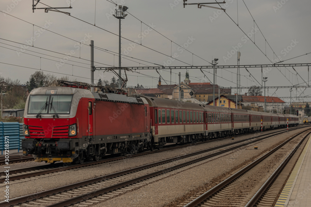 Fast passenger train with red modern electric engine in Ilava station
