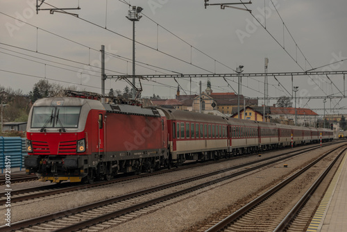 Fast passenger train with red modern electric engine in Ilava station