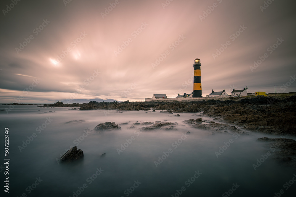 The St. John's Point Lighthouse in Northern Ireland photographed at sunset.