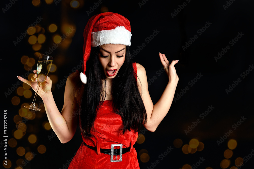 Young and sexy brunette girl in a red dress in a white background. Playful and funny expression. Lifesytle. Beauty. Celebrating New Year 2020 Young and sexy brunette girl in a red dress in a white background. Playful and funny expression. Lifesytle. Beauty. Celebrating New Year 2020