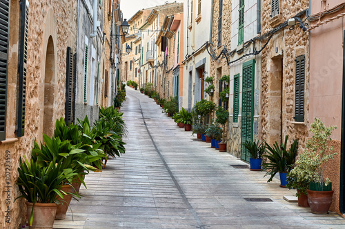 Fototapeta Naklejka Na Ścianę i Meble -  Typical Mallorcan village street with pots and plants on the sides