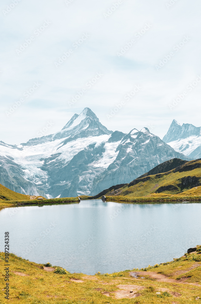 Beautiful Bachalpsee in the Swiss Alps photographed with famous mountain peaks Eiger, Jungfrau, and Monch. Alpine lake and landscape. Snow-capped mountains, mountain range. Switzerland nature