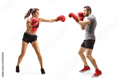 Young man and woman fighting with boxing gloves