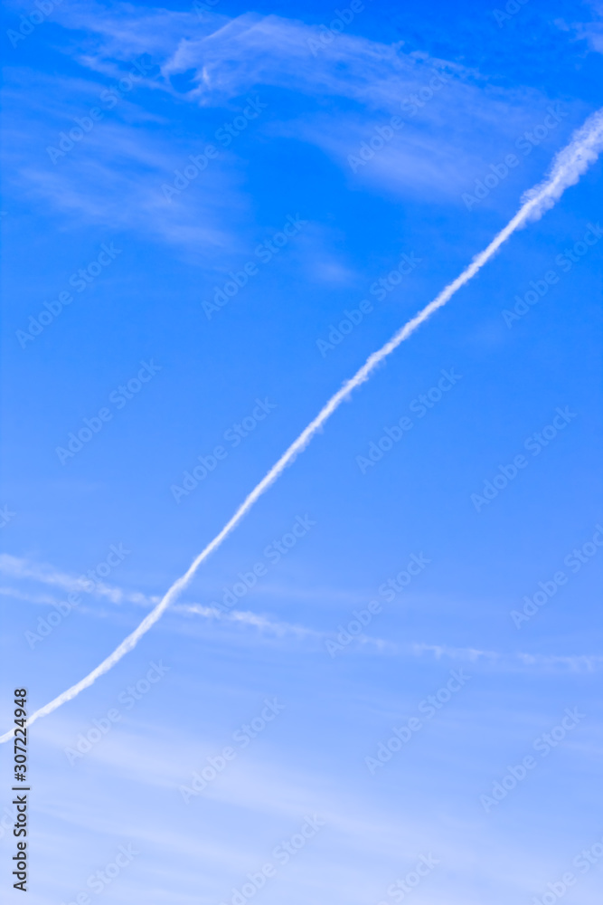 Blue sky with white condensation trail Blue sky with white condensation trail