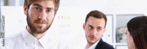 Handsome smiling bearded man in office