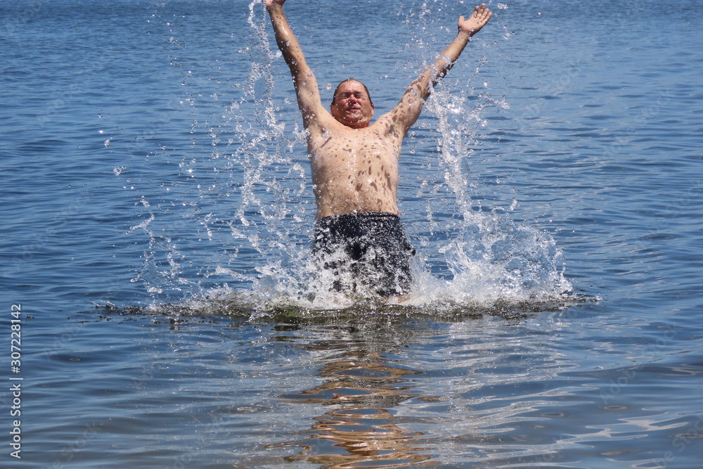man jumping into water