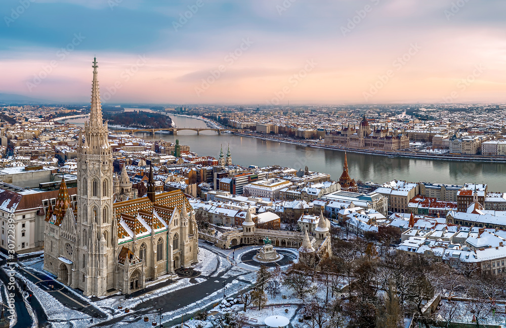 Fototapeta premium Aerial cityscape from Budapest with cloudly sky, Matthas church, fishermans bastion, Danube river and Hungarian Parliament.