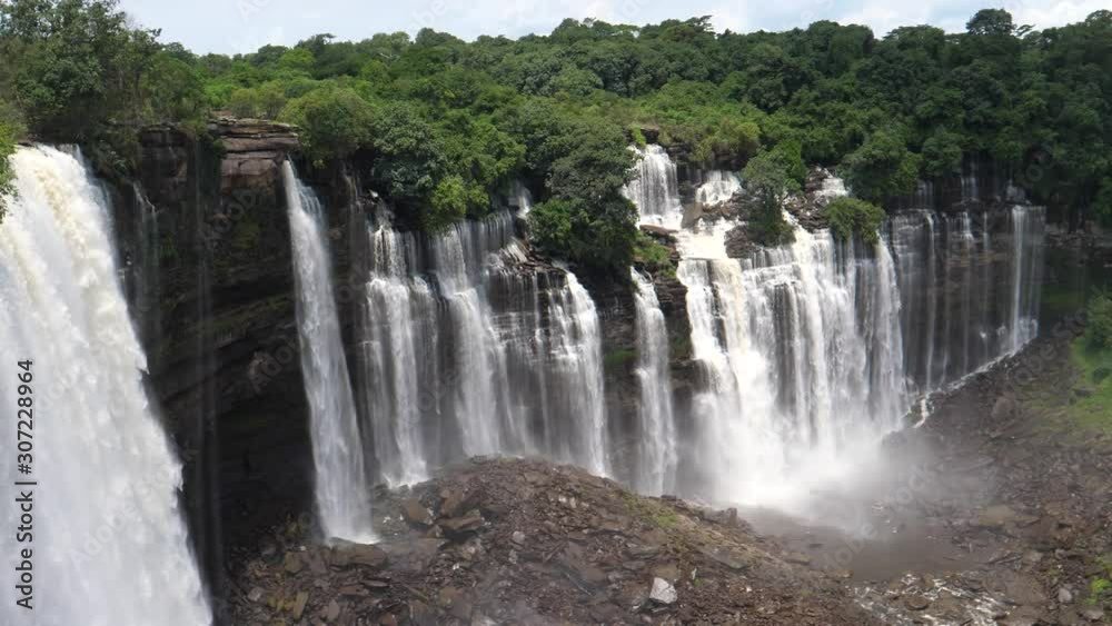 Pan from streams of water falling down at the Kalandula Falls in Angola Pan from streams of water falling down at the Kalandula Falls in Angola