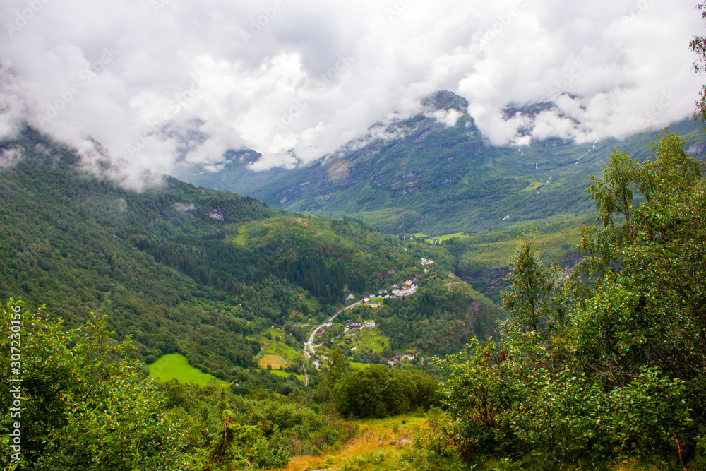 View of the mountain valley. Around everything is covered with green trees