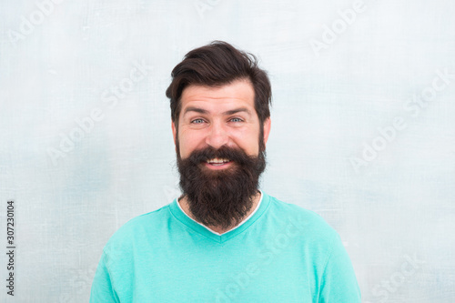 Happy face. Hipster appearance. Beard fashion and barber concept. Perceptions of male beauty around the world. Man bearded hipster stylish beard grey background. Stylish beard and mustache care © be free