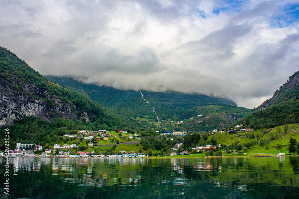 View from the fjord to a small village inside the mountains