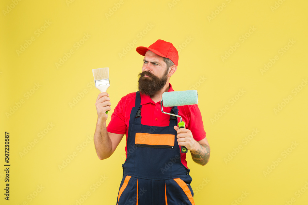 Pick tools. Painting tool. Brush roller painter. Man bearded laborer