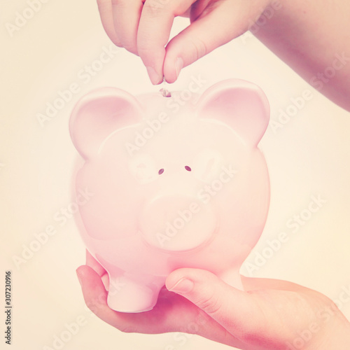 Putting Money in Piggy Bank
