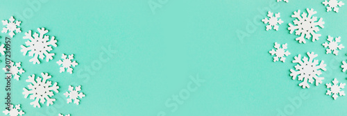 Banner with popular color 2019-2020 Biscay Green. Wooden white snowflakes of different sizes.