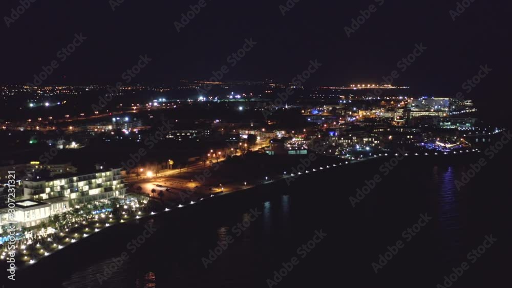 Aerial view of Paphos embankment or promenade at night with reflection of city lights in sea water. Famous Cyprus mediterranean resort Aerial view of Paphos embankment or promenade at night with reflection of city lights in sea water. Famous Cyprus mediterranean resort