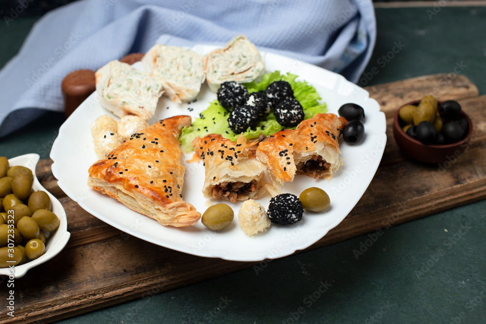 bun with meat, lavash roll and olives on the table bun with meat, lavash roll and olives on the table