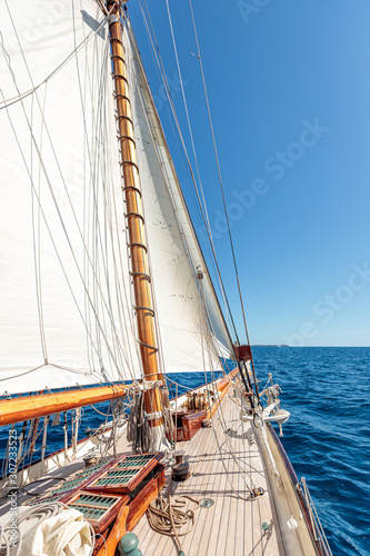Vertical high angle shot of the deck of a schooner sailing in the sea