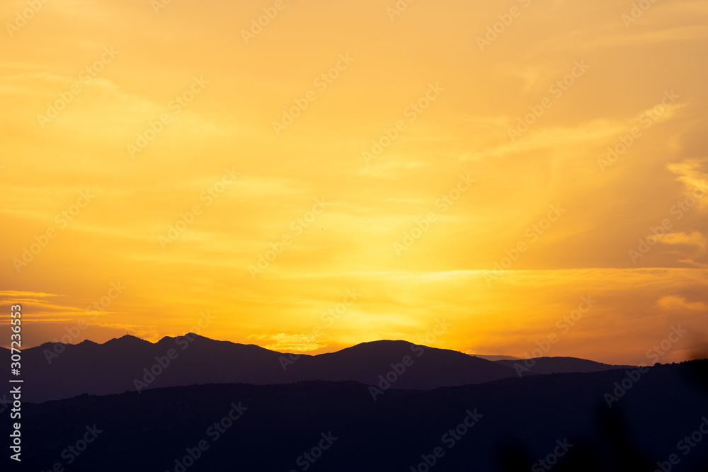 Beautiful silhouette of mountains during sunset with a golden sky