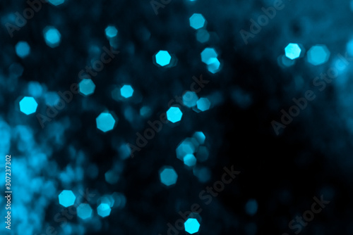 Photo of bokeh lights on black background. Blue lights, mint color.