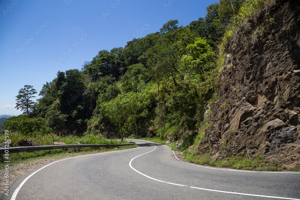 Winding mountain road. Serpentine road in the mountains. Dangerous area on the road in the mountains