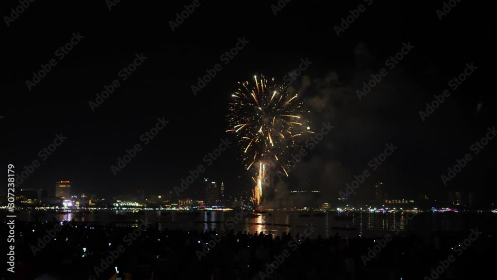 Real fireworks background and people who come to watch on the beach Pattaya International Fireworks Festival. New year's eve fireworks celebration Asia Thailand Real fireworks background and people who come to watch on the beach Pattaya International Fireworks Festival. New year's eve fireworks celebration Asia Thailand