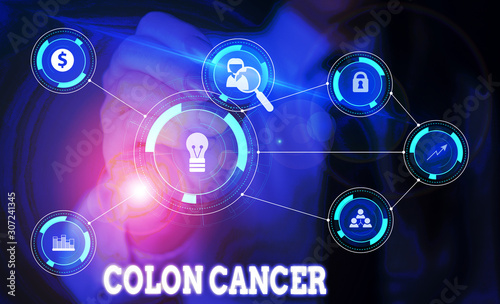 Handwriting text writing Colon Cancer. Conceptual photo the development of cancer cells from the colon or rectum Woman wear formal work suit presenting presentation using smart device