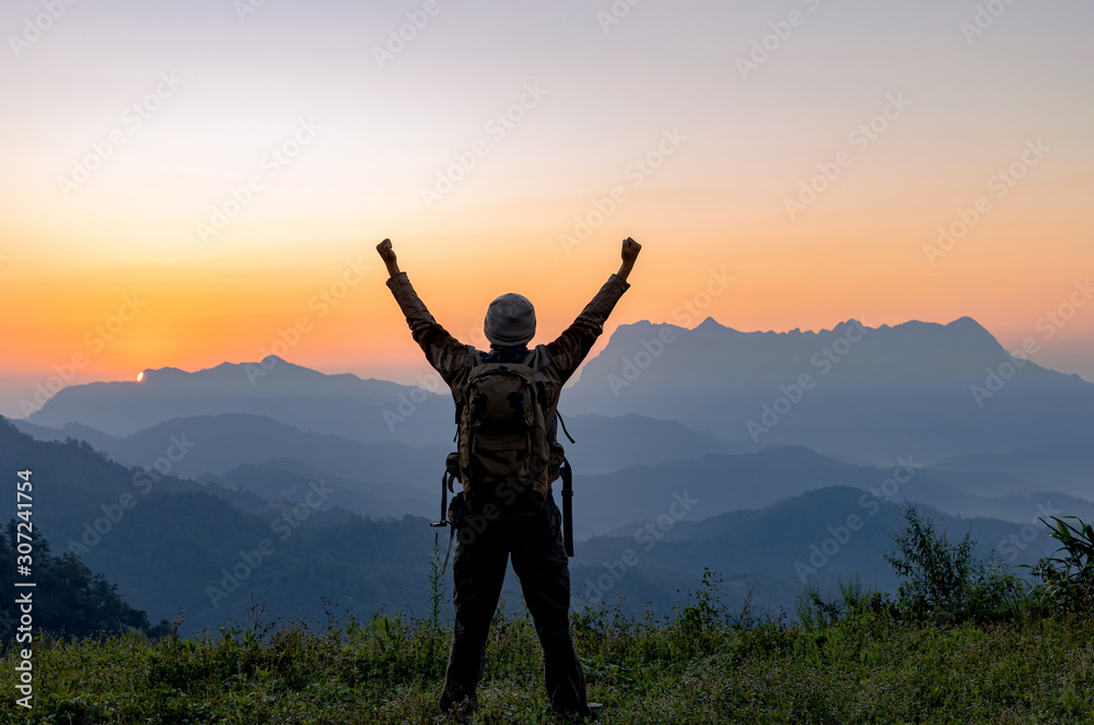 Silhouette of hiker man on top of mountain. successful people concept