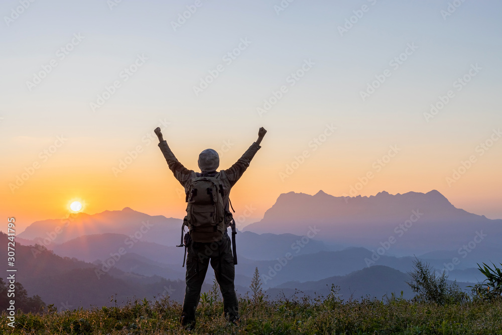 Silhouette of hiker man on top of mountain. successful people concept