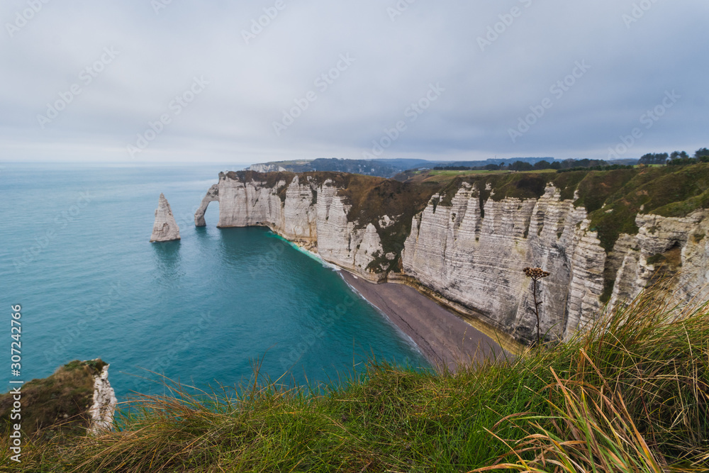 Obraz premium Panoramatic view on Etretat steep rock coastal cliffs at north of France, served as many inspiration for Monet, the impresionist painter