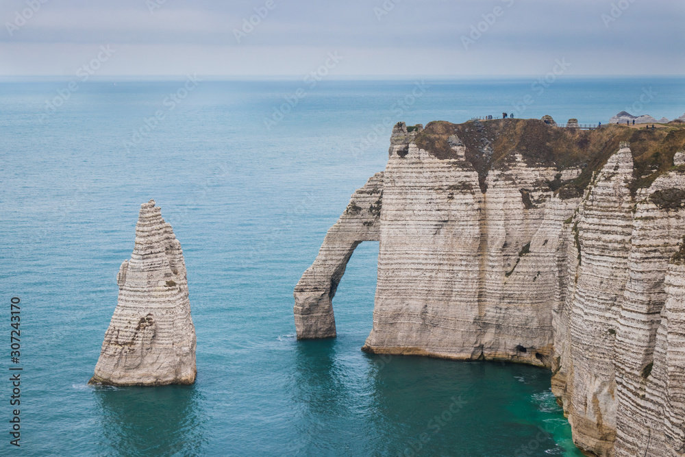 Fototapeta premium Panoramatic view on Etretat steep rock coastal cliffs at north of France, served as many inspiration for Monet, the impresionist painter