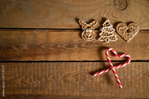Gingerbread cookies and Christmas sweets on wooden table