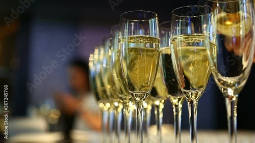The bartender pours sparkling wine into a glass