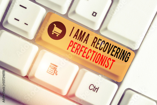 Text sign showing I Am A Recovering Perfectionist. Business photo showcasing Obsessive compulsive disorder recovery White pc keyboard with empty note paper above white background key copy space photo