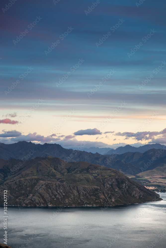 Sunrise sky mountain landscape. Early dawn morning colorful sky with scenic view over mountains in New Zealand. Roys Peak Wanaka
