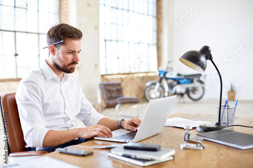 Businessman with pencil behind ear