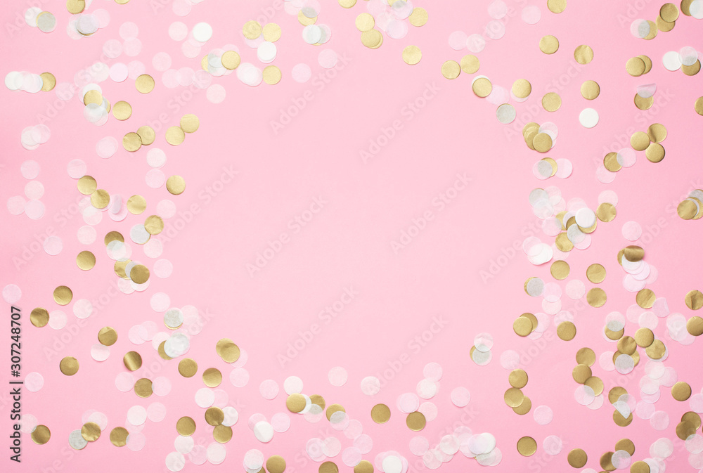 Paper confetti in pale pink, white and golden on pastel pink background, top view, selective