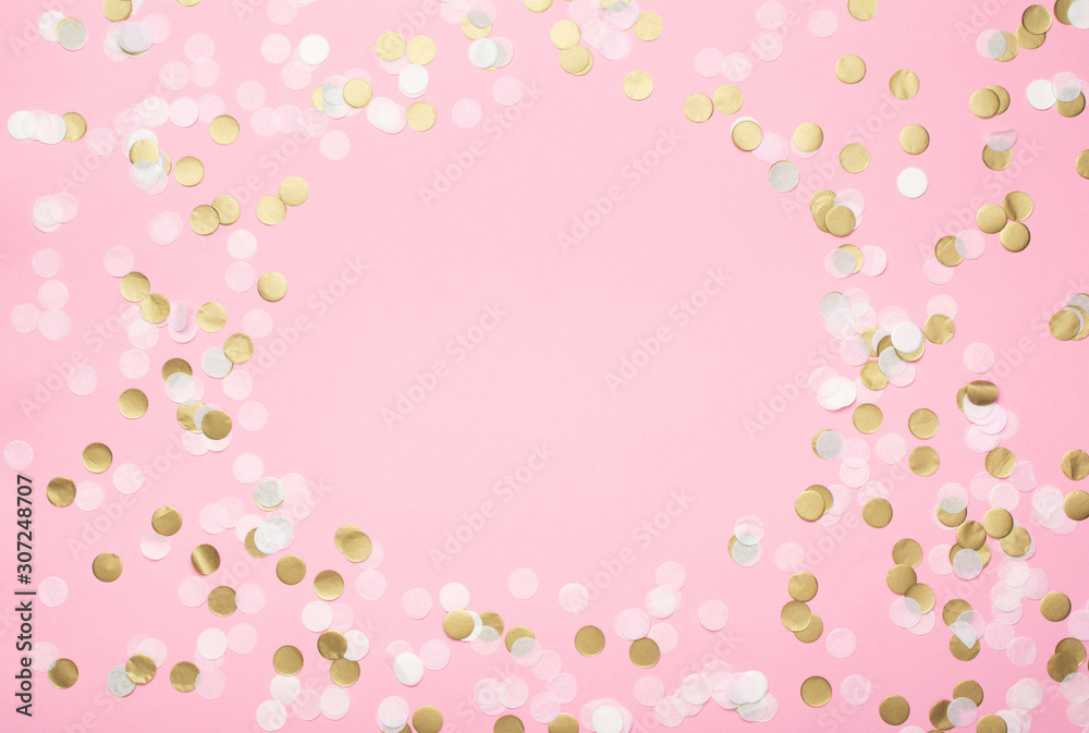 Paper confetti in pale pink, white and golden on pastel pink background, top view, selective Paper confetti in pale pink, white and golden on pastel pink background, top view, selective