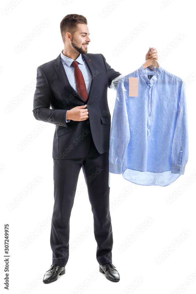 Male worker of modern dry-cleaner with clothes on white background Male worker of modern dry-cleaner with clothes on white background