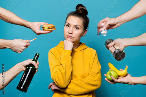 from different angles the girl is offered healthy and not healthy things