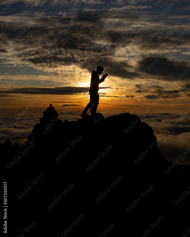 silhouette of man at sunset