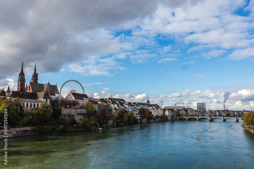 Look at boardwalk in Basel over the Rhine river - city near Switzerland, Germany and France, included cathedrals two towers and russian wheel