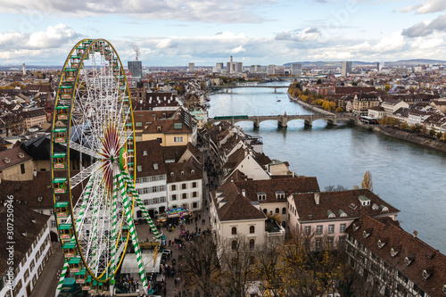 Look at boardwalk in Basel - city near Switzerland, Germany and France, look from cathedrals tower towards russian wheel over the river Rhine