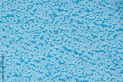 Fabric texture with spots. Textile material background with abstract pattern, close up. Carpet texture with blue dots.