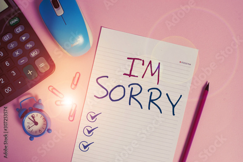 Writing note showing I M Sorry. Business concept for Toask for forgiveness to someone you unintensionaly hurt Calculator clips alarm clock mouse sheet pencil colored background photo