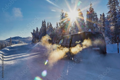 Winter road in the mountains. Stopover. Frost and sun photo