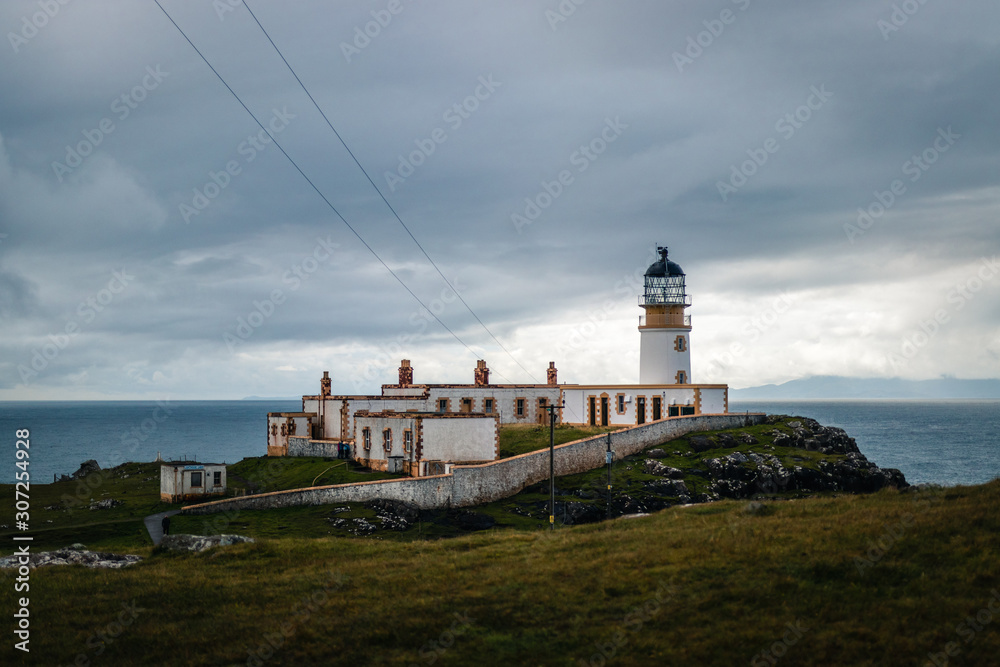 Close view to the nest point lighthouse located on isle of Skye in Scotland under cloudy sky Close view to the nest point lighthouse located on isle of Skye in Scotland under cloudy sky
