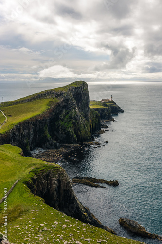 Famous lighthouse on isle of Skye in Scotland, Point nest, view over the approaching path, over the green meadow
