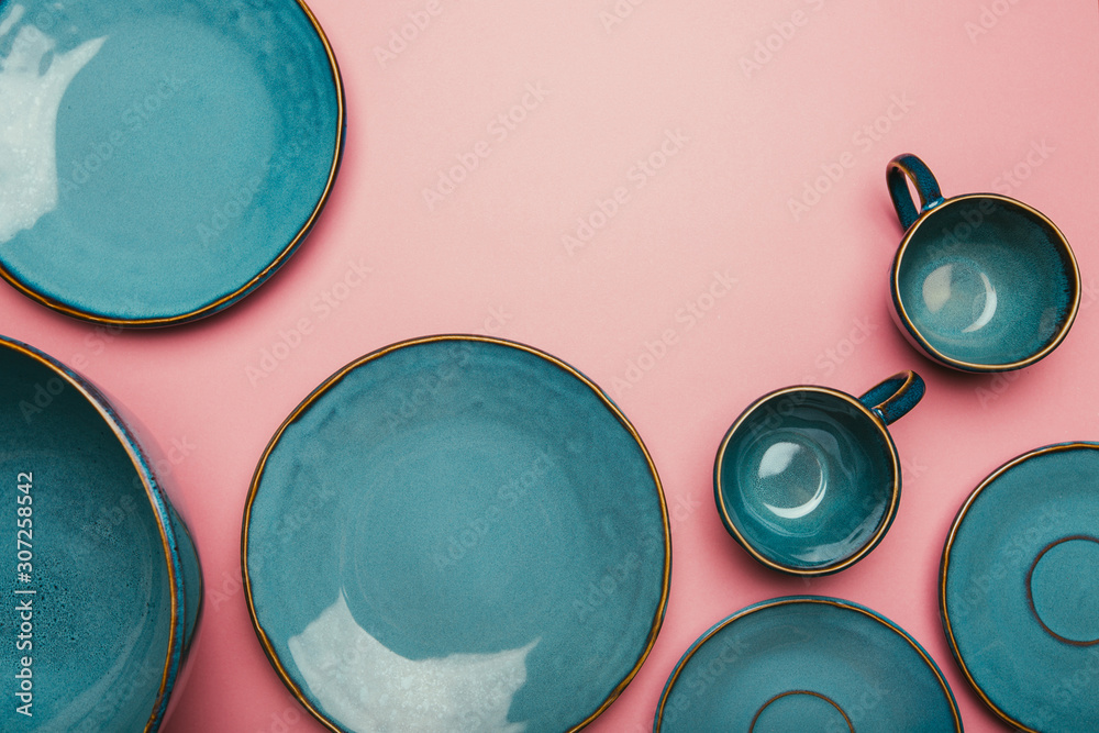 Set of clean dishes and cups on color background. - obrazy, fototapety, plakaty 